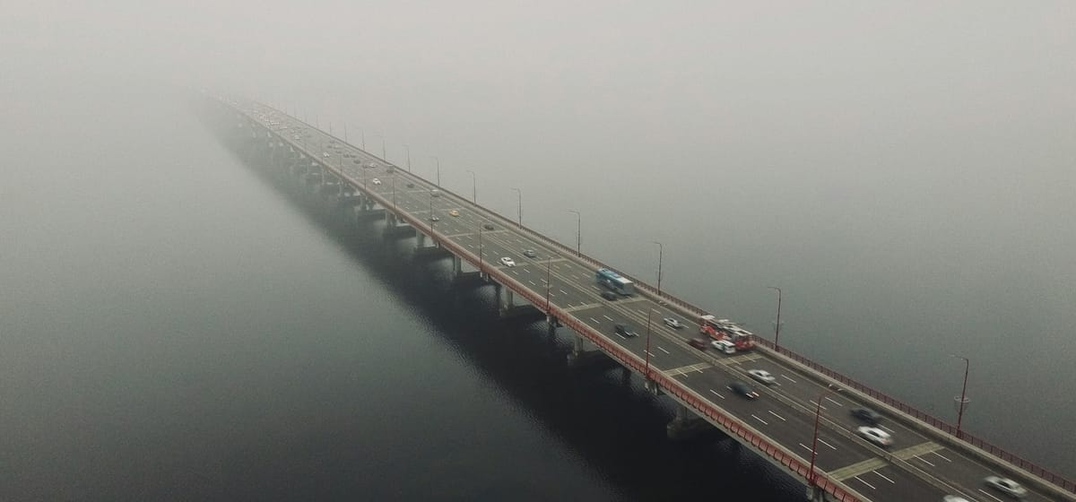 Illustration of a bridge in heavy fog with cars within stock loan market