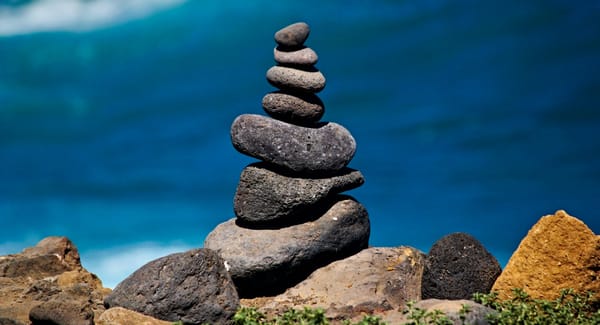 The illustration shows a stone pyramid against the backdrop of the sea within the stock loan market